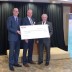 Scott McDonald, managing broker of Re/max Sabre presenting the donation with Mayor Greg Moore.